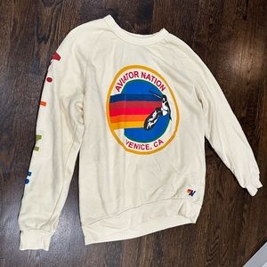 Cream/ White aviator nation crewneck with logo on front and “aviator nation” arm